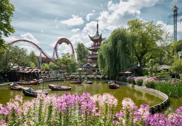 Boats sailing in the lake in Tivoli with the Demon rollercoaster in the background. eee